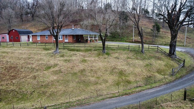 view of yard featuring fence and a rural view