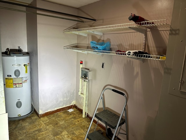 laundry room with hookup for a washing machine, laundry area, electric water heater, and baseboards