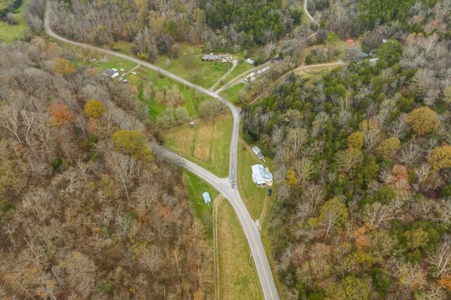 birds eye view of property with a forest view