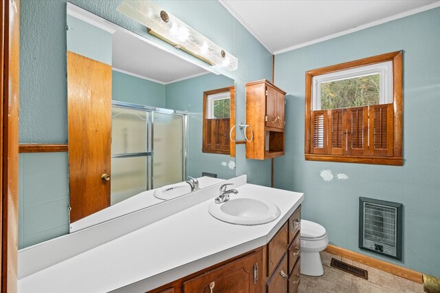 full bathroom featuring crown molding, heating unit, visible vents, toilet, and a stall shower