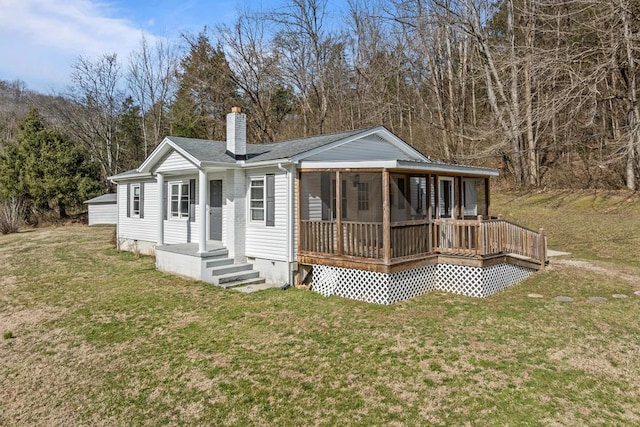 back of property with a yard, crawl space, a chimney, and roof with shingles