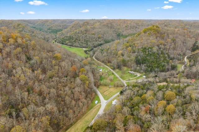 aerial view featuring a wooded view