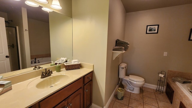 bathroom with vanity, tile patterned flooring, a bath, and baseboards