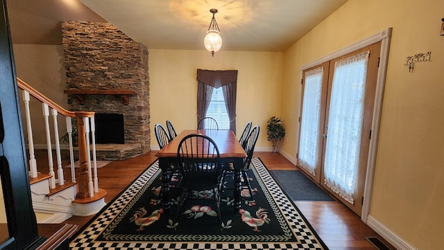 dining area with dark wood-style floors, french doors, stairway, and visible vents