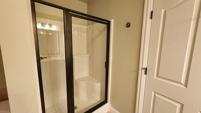 full bath featuring a shower stall