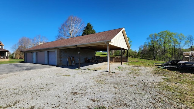 view of home's exterior featuring a detached garage and an outdoor structure