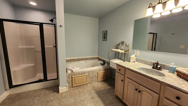 full bathroom featuring a stall shower, tile patterned flooring, a garden tub, and vanity