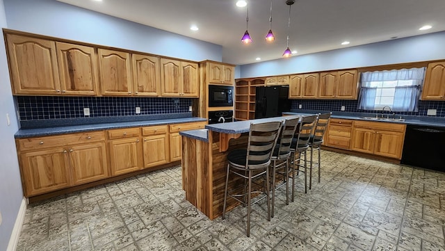 kitchen with brown cabinetry, dark countertops, a kitchen island, a kitchen breakfast bar, and black appliances