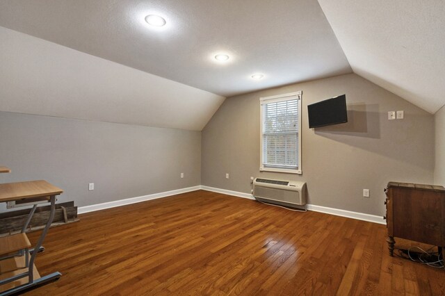 bonus room with vaulted ceiling, wood-type flooring, and baseboards