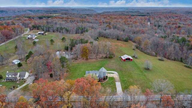 birds eye view of property featuring a forest view and a rural view