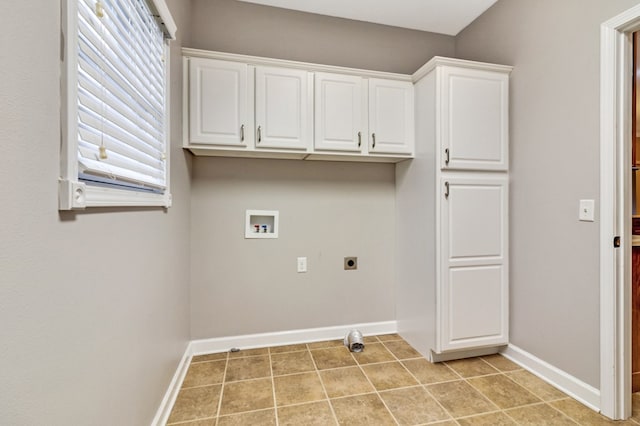 washroom featuring cabinet space, baseboards, hookup for an electric dryer, washer hookup, and light tile patterned flooring