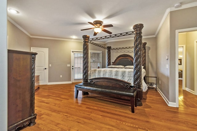 bedroom with baseboards, ceiling fan, wood finished floors, and crown molding