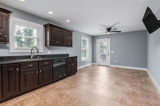 kitchen featuring dishwasher, dark brown cabinets, a sink, and a wealth of natural light