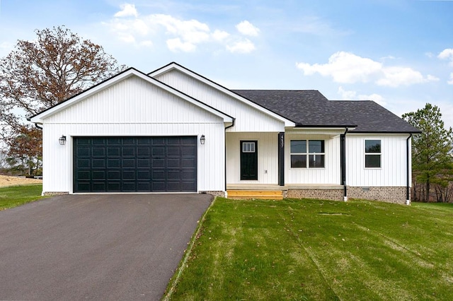 modern farmhouse style home with a garage, driveway, a shingled roof, and a front yard