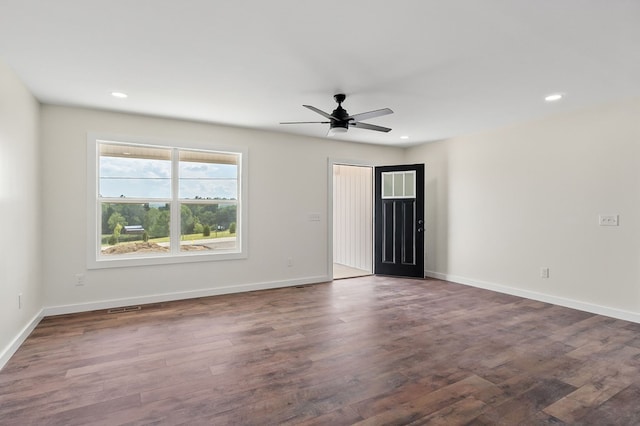 empty room featuring recessed lighting, dark wood finished floors, a ceiling fan, and baseboards