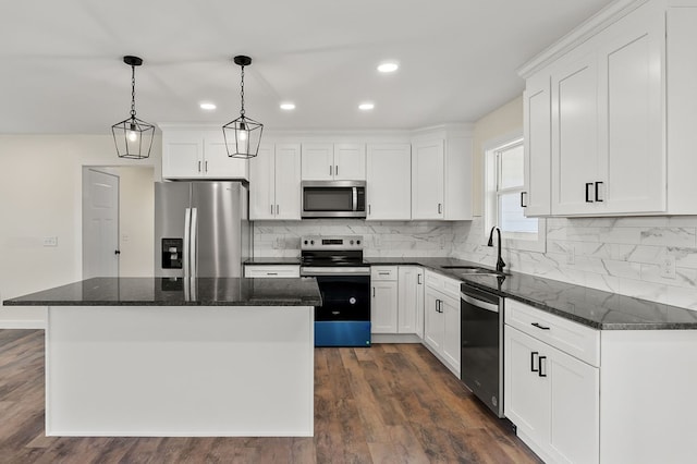 kitchen featuring white cabinetry, appliances with stainless steel finishes, and a center island