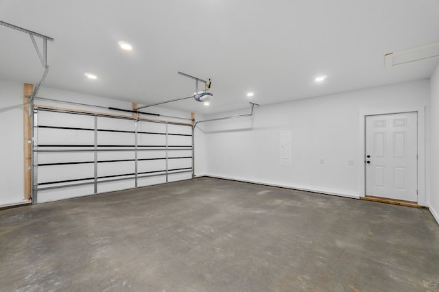 garage with recessed lighting and a garage door opener