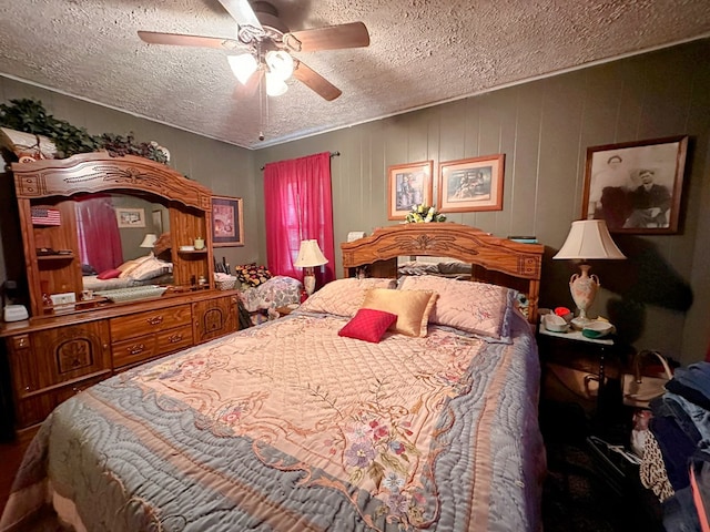 bedroom with a ceiling fan and a textured ceiling