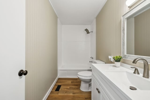 bathroom with shower / tub combination, toilet, wood finished floors, vanity, and visible vents