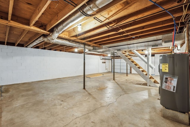 unfinished basement featuring water heater and stairs