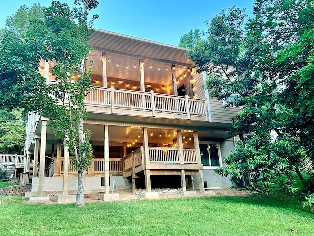 rear view of property featuring a lawn