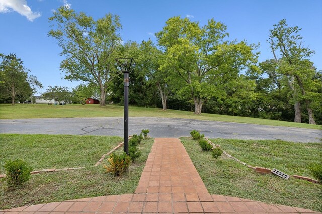 view of sport court with a yard