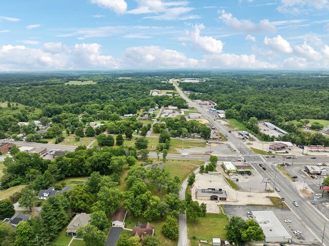 drone / aerial view with a wooded view