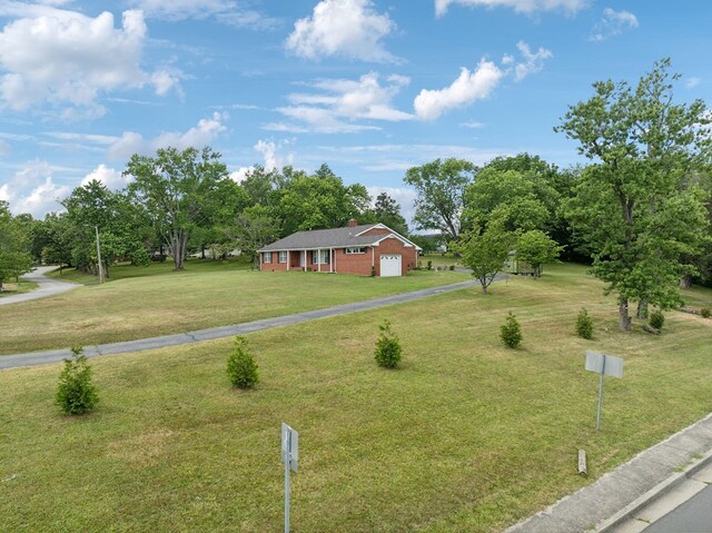 view of front of house featuring a garage, a front yard, and driveway