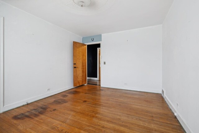 empty room with wood finished floors and baseboards