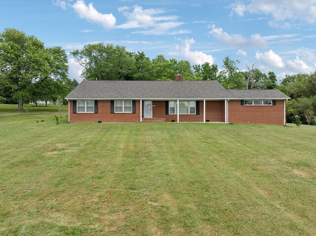 ranch-style home featuring crawl space, brick siding, a chimney, and a front yard