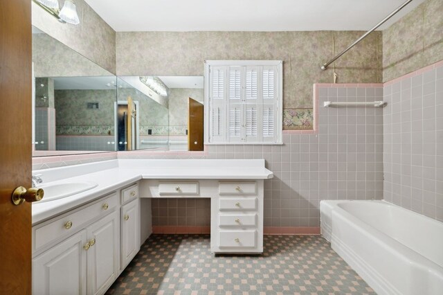 full bathroom with tile walls, bathtub / shower combination, vanity, and tile patterned floors