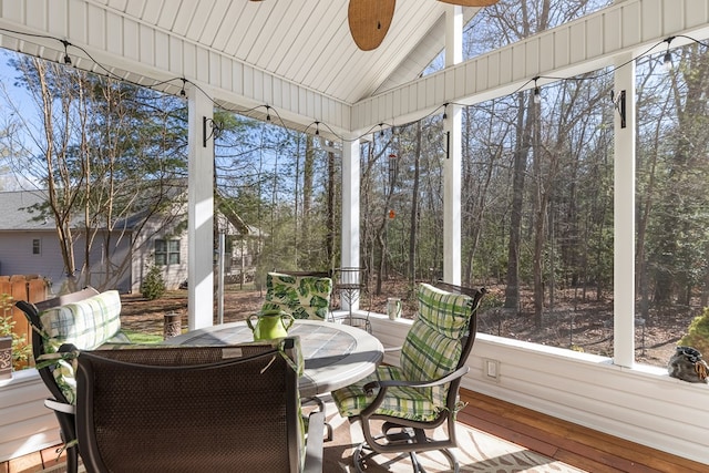 sunroom / solarium featuring lofted ceiling and ceiling fan