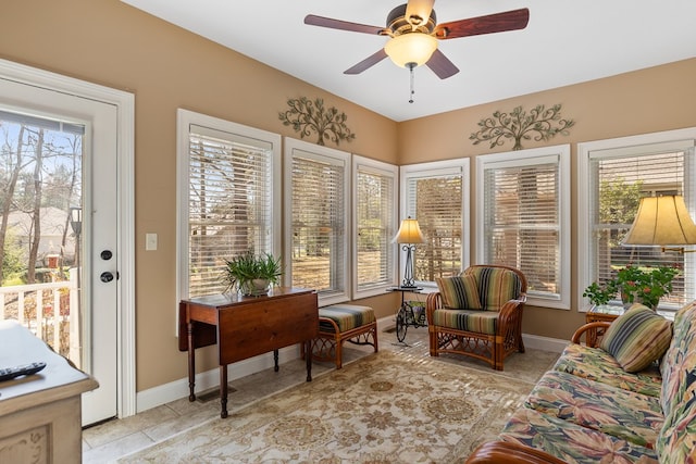 sunroom / solarium featuring ceiling fan