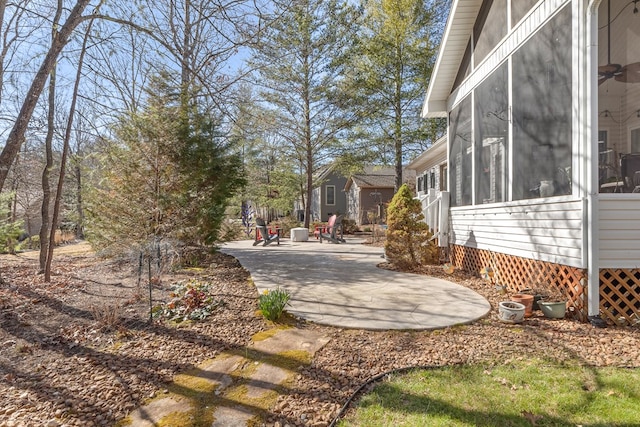 view of yard featuring a patio and a sunroom