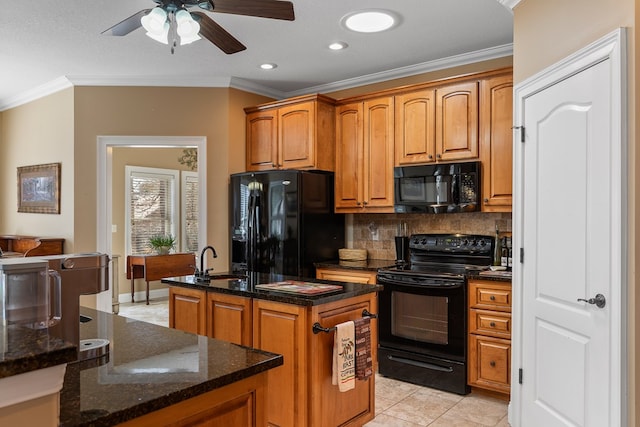 kitchen featuring decorative backsplash, black appliances, a center island with sink, and ornamental molding