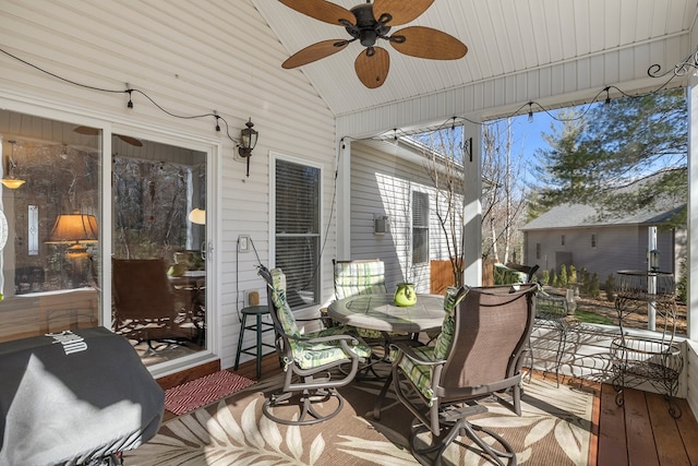 sunroom / solarium featuring vaulted ceiling and a ceiling fan