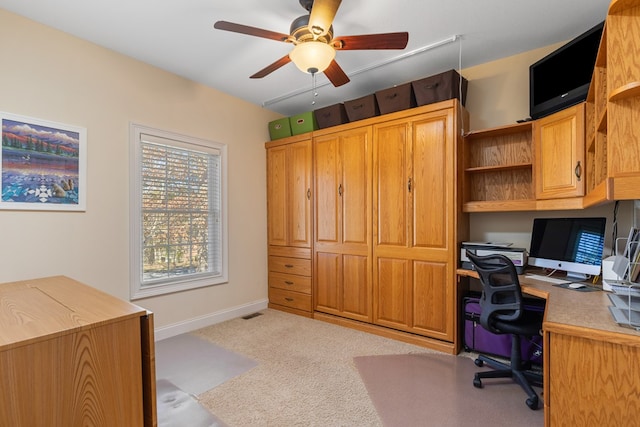 office area featuring baseboards, carpet floors, and ceiling fan