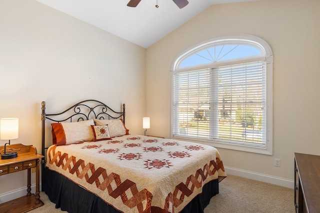 carpeted bedroom with multiple windows, ceiling fan, baseboards, and vaulted ceiling