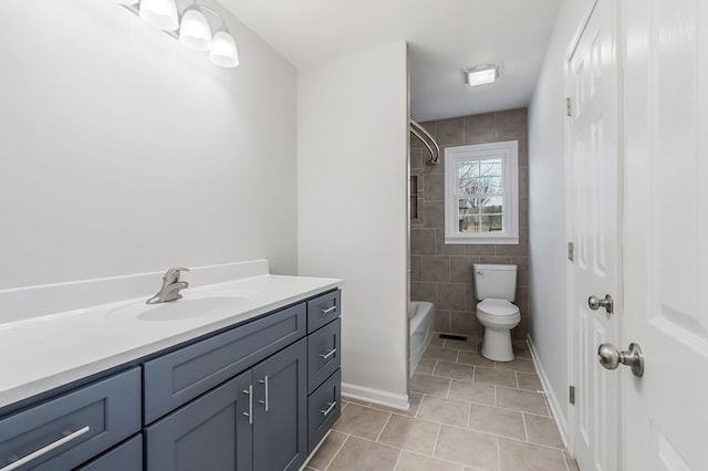 bathroom with baseboards, toilet, tile patterned floors, vanity, and washtub / shower combination