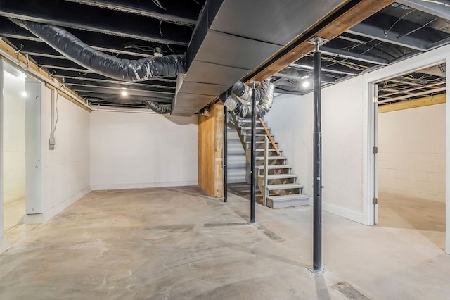 unfinished basement featuring stairs