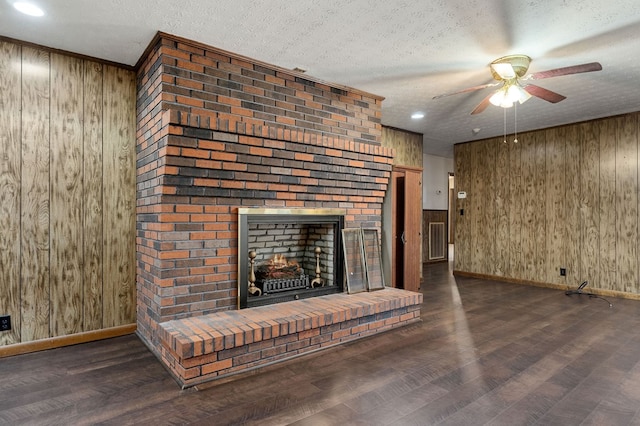 unfurnished living room featuring dark wood-style floors, a fireplace, and a textured ceiling