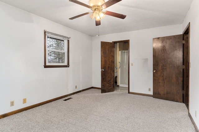 unfurnished bedroom featuring visible vents, baseboards, a ceiling fan, and light colored carpet