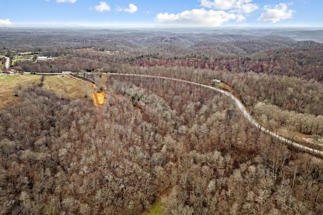 birds eye view of property with a forest view