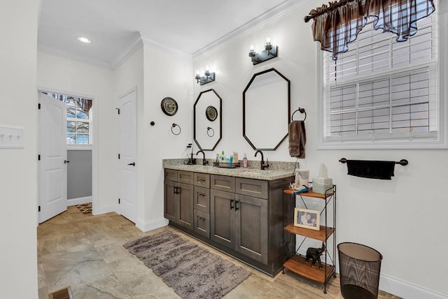 bathroom featuring double vanity, baseboards, visible vents, crown molding, and a sink