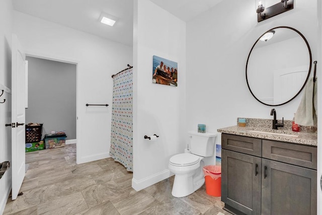 bathroom featuring toilet, a shower with curtain, baseboards, and vanity