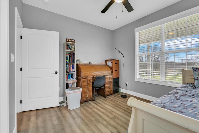 bedroom with baseboards, ceiling fan, and light wood-style floors