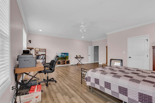 bedroom with light wood finished floors, multiple windows, and crown molding