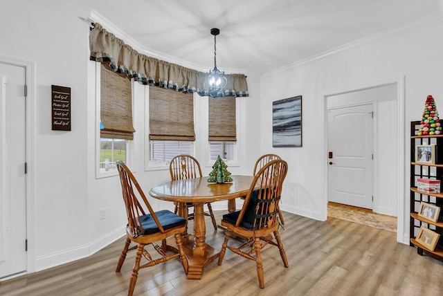 dining room featuring baseboards, ornamental molding, and wood finished floors