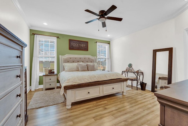 bedroom featuring ornamental molding, multiple windows, and light wood finished floors