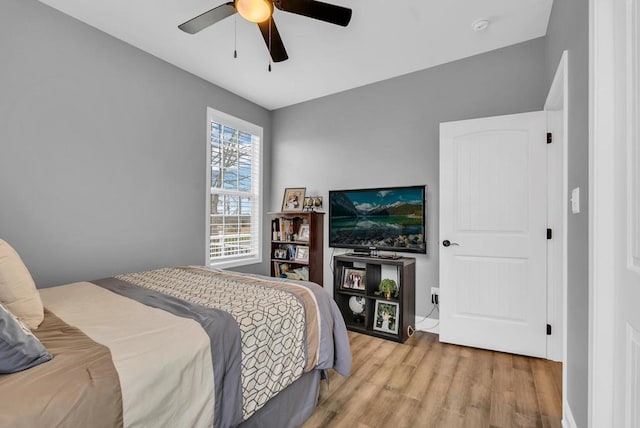 bedroom with ceiling fan and light wood finished floors